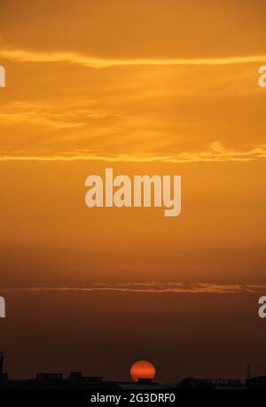 Beautiful view of the sunset sky with shades of orange over the city ...