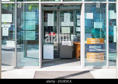Information noise, an overabundance of messages on sheets of paper stuck to the windows at the entrance to the office. Gniezno, Poland Stock Photo