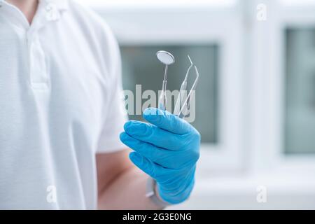Close up pictire of doctors hands with dental medical tools Stock Photo