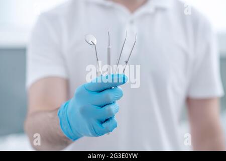 Close up pictire of doctors hands with dental medical tools Stock Photo