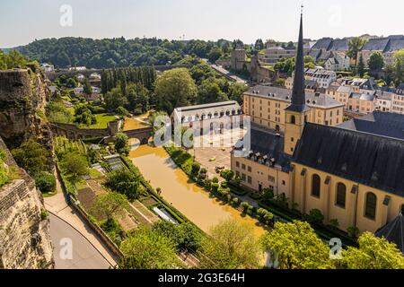 Casemates du Bock in Luxembourg. Neumünster Abbey on the banks of the Alzette River in the Grund district. In the courtyard modern seating sculptures. On the terraces along the old fortification wall is also grown wine Stock Photo