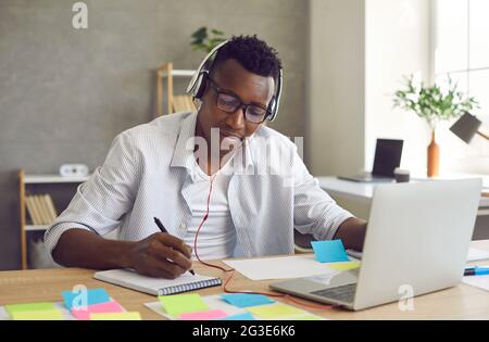 African american student study online listening and watching webinar on laptop Stock Photo