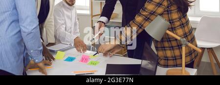 Diverse business team hands over office desk with color sticker midsection shot Stock Photo