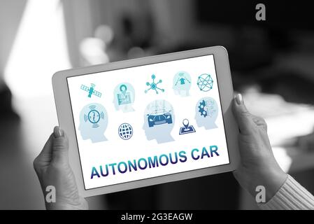 Autonomous car concept shown on a tablet held by a woman Stock Photo