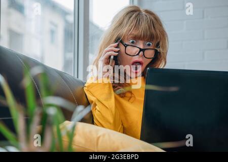 surprised woman looking at computer Stock Photo