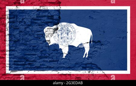 State of Wyoming flag is painted onto an old brick wall Stock Photo