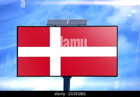 Billboard with Denmark flag and solar battery on blue sky background