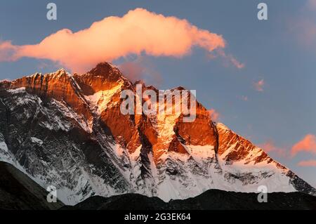 evening view of Lhotse and clouds on the top, warm tone - way to mount Everest base camp, khumbu valley, Nepal Stock Photo