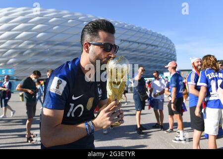 Muenchen/Germany, June 15, 2021, A fan from FRA kisses a dummy of the World Cup, in front of the stadium, Allianz-Arena group stage, preliminary round group F, match M12, France (FRA) - Germany (GER), on June 15, 2021 in Muenchen/Germany. Football EM 2020 from 06/11/2021 to 07/11/2021. Â Stock Photo