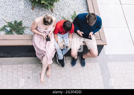 Family using new technologies outside on summer day. Lifestyle. High quality photo. Stock Photo