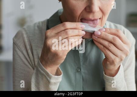 Close up of unrecognizable mature woman rolling cigarette for medicinal purposes, copy space Stock Photo