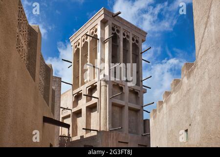 Looking up at a traditional ventilation wind tower for keeping a house cool, in the old quarter of Dubai, the UAE, United Arab Emirates Stock Photo