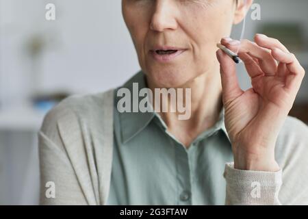 Close up of unrecognizable mature woman smoking cigarette at home for medicinal purposes, copy space Stock Photo