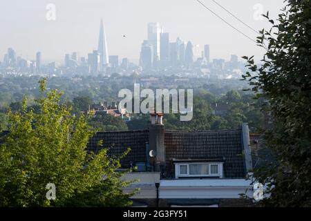 Houses and flats with an elevated viewpoint of the London skyline at Crystal Palace, on 16th June 2021, in London, England. Stock Photo