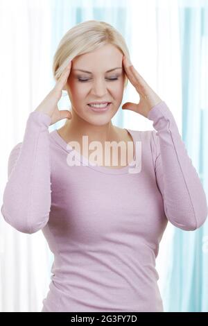 Blonde wife with headache Stock Photo - Alamy