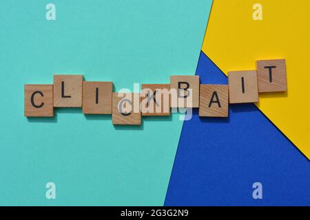 Clickbait, business buzzword in wood alphabet letters isolated on multi coloured background Stock Photo