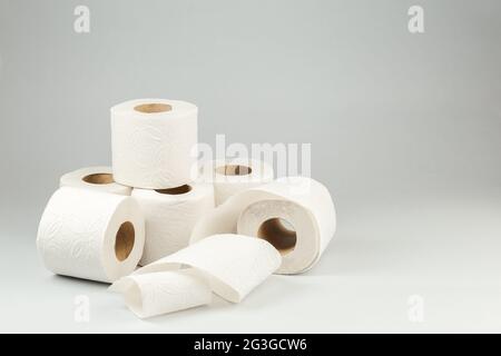 Rolls of White Toilet Paper over Gray Background. Copy Space for text Stock Photo