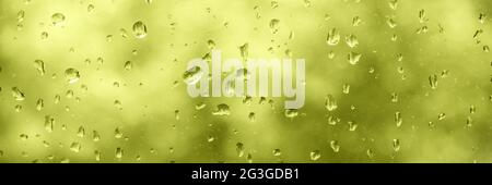 Water drops on a window, greeny panoramic rainy background Stock Photo
