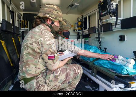 Medical staff from the military services during a test of the Army Medical Service's Mytchett based 22 Field Hospital, at Barton Stacey in Hampshire. The 22 Field Hospital is about to assume the mantle of the Army's High Readiness Hospital, meaning they can expect to be put on five days' notice to deploy - that could be to serve on an overseas operation, or to provide humanitarian relief in the case of a natural disaster anywhere around the world. Picture date: Wednesday June 16, 2021. Stock Photo