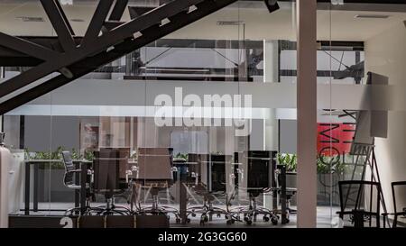 Interior of conference room with computers, view through glass wall Stock Photo