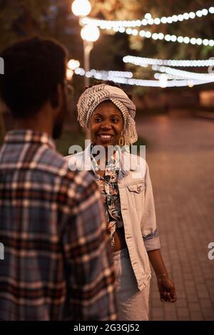 African young couple walking together in the evening in the park Stock Photo