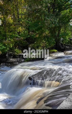 Shohola Falls along Shohola Creek in Pennsylvania's Pocono Mountains has numerous cascades before falling the final 50 feet into the main plunge pool. Stock Photo
