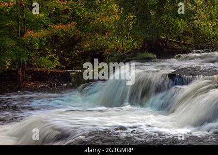 Shohola Falls along Shohola Creek in Pennsylvania's Pocono Mountains has numerous cascades before falling the final 50 feet into the main plunge pool. Stock Photo