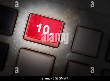 Red button on a dirty old panel Stock Photo