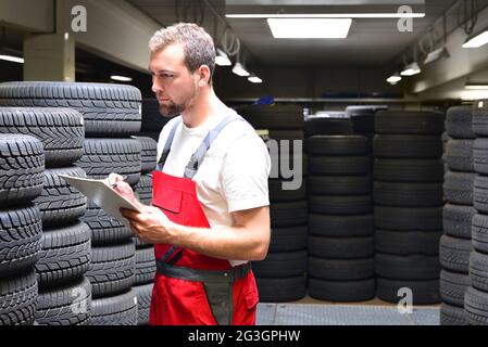 department store with car tyres in a garage - tyre change Stock Photo
