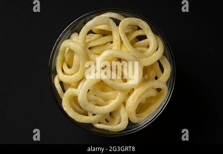 Crispy onion rings in bowl on black background, top view Stock Photo