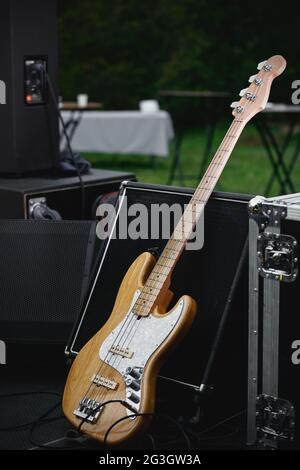 Bass guitar and the amp on the outdoor stage. Stock Photo