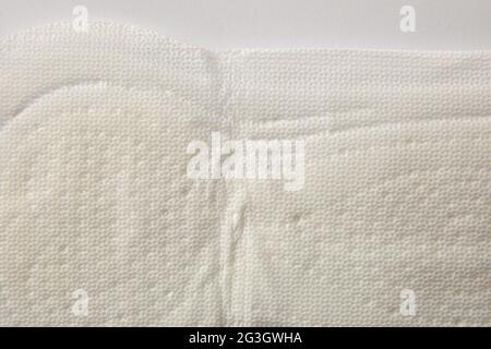 Soft protective and absorbent cotton wipe for women's care macro on white background. Top view. Horizontal composition. Stock Photo