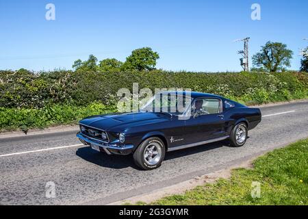1967 60s sixties black American Ford Mustang Auto 4736 cc petrol roadster,  en-route to Capesthorne Hall classic May car show, Cheshire, UK Stock Photo