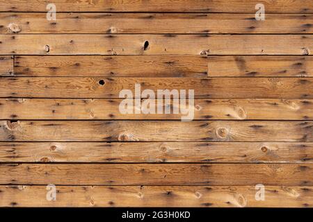Brown wood plank wall with nails, holes, and knots in a texture background Stock Photo