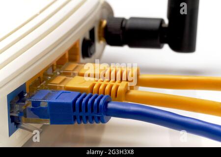 close up on three network cables connected to WAN and LAN ports on wi-fi router Stock Photo