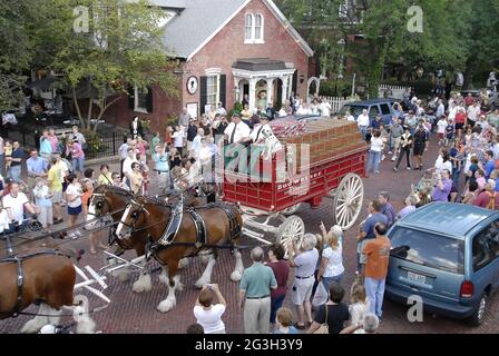 ST. CHARLES, UNITED STATES - Jul 18, 2009: The Budweiser Clydesdale horse team pulling the red beer wagon at a promotional event in St. Charles, Misso Stock Photo