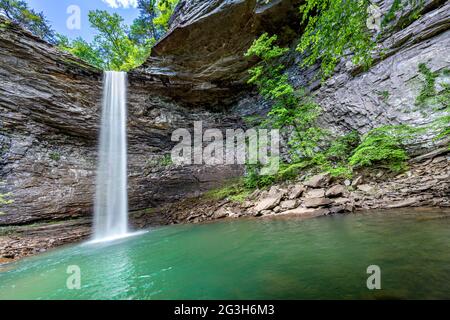 Beautiful Ozone Falls in Cumberland County Tennessee is a scenic swimming hole with a cool, cascading waterfall feeding the pool. Stock Photo