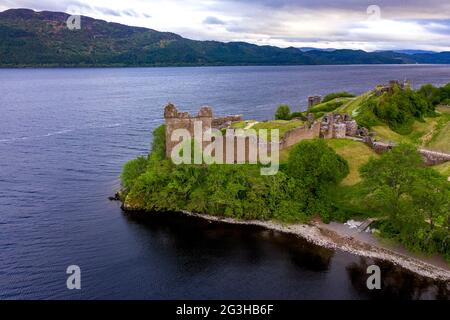 Urquhart Castle, Loch Ness, Scotland, UK. 12 June 2021. Pictured: Drone aerial photography view from above of Urquhart Castle, a ruin, sits beside Loch Ness in the Highlands of Scotland. The castle is on the A82 road, 21 kilometres south-west of Inverness and 2 kilometres east of the village of Drumnadrochit. Credit: Colin Fisher/Alamy Live News. Stock Photo