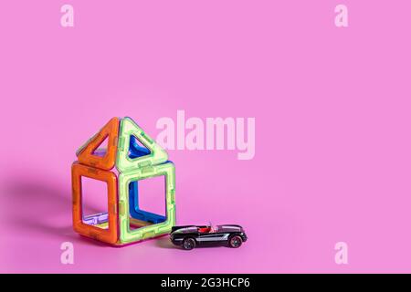 children's magnetic designer for development of motor skills, thinking and imagination. construction assembled from multi-colored parts of children's Stock Photo