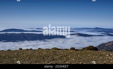Winter views from Sant Alís, the highest peak of Montsec, with a sea of fog in the Ebro depression (Pallars Jussà, Catalonia, Spain, Pyrenees) Stock Photo