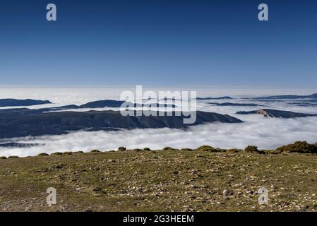 Winter views from Sant Alís, the highest peak of Montsec, with a sea of fog in the Ebro depression (Pallars Jussà, Catalonia, Spain, Pyrenees) Stock Photo
