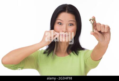 Woman locked mouth with key on white Stock Photo