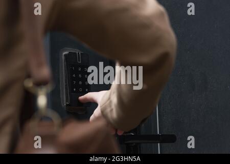partial view of man pressing button on intercom keypad Stock Photo
