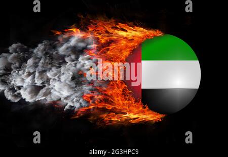 Flag with a trail of fire and smoke - United Arab Emirates Stock Photo