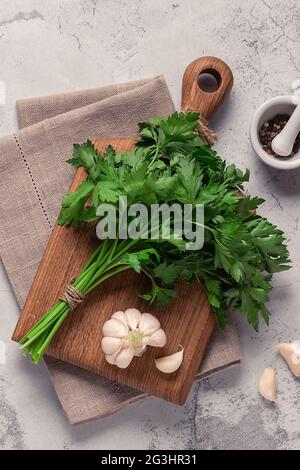 cutting board, parsley on a concrete table, top view Stock Photo