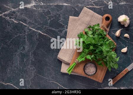 cutting board, parsley on a marble table, top view Stock Photo