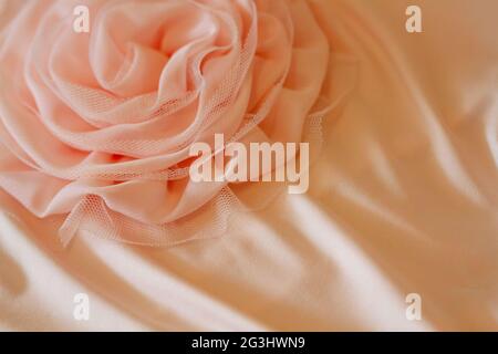 Beautiful rose from fabric, bright festive wedding background. Copy space Stock Photo