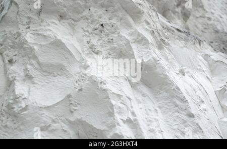 Chalk mining. Limestone quarry. Opencast mining. Chalk hills. Chalk surface. White Stone Texture background wallpaper. Stock Photo