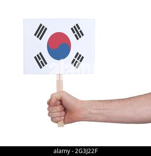 Hand holding small card - Flag of South Korea Stock Photo