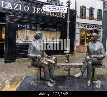 The bronze statues of Oscar Wilde, the Irish writer and the Estonian writer Eduard Vilde, in earnest conversation, on William Street, Galway Ireland. Stock Photo